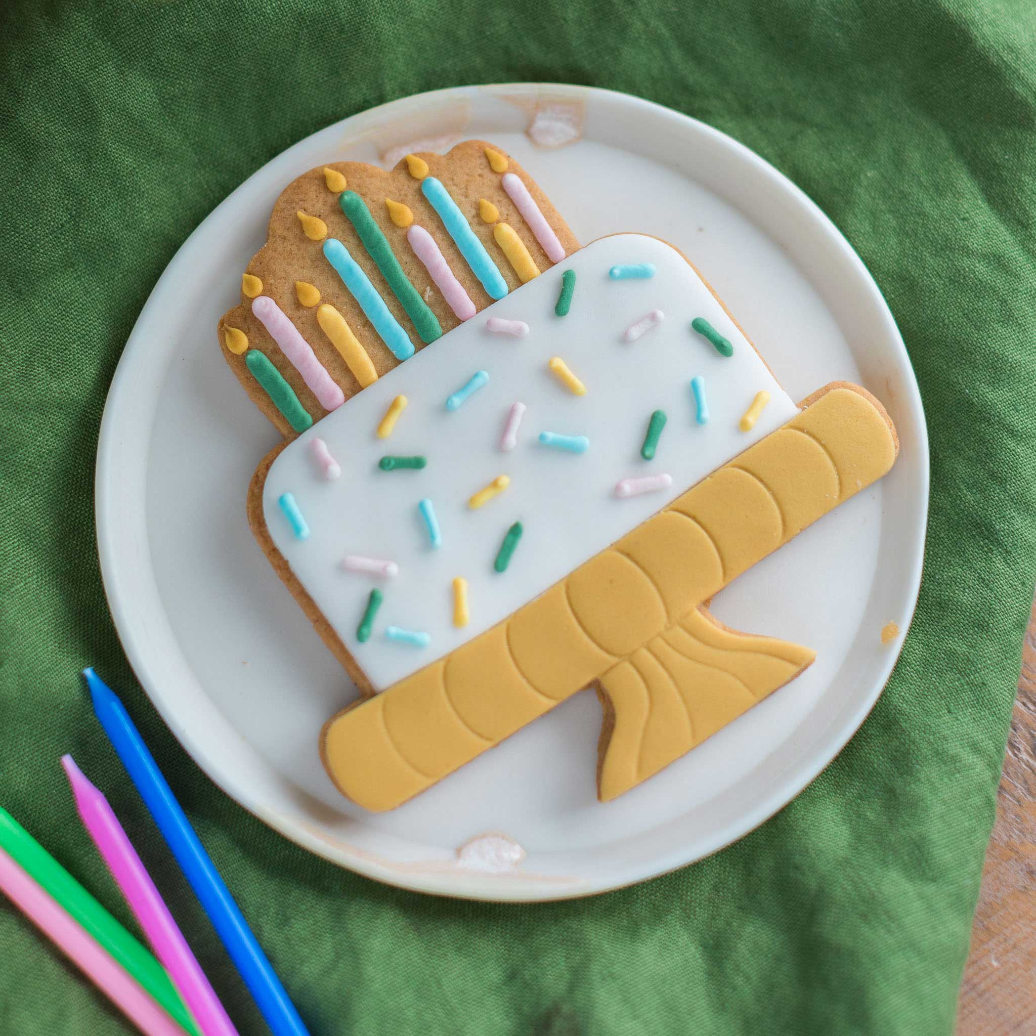 birthday cake biscuit with colourful candles