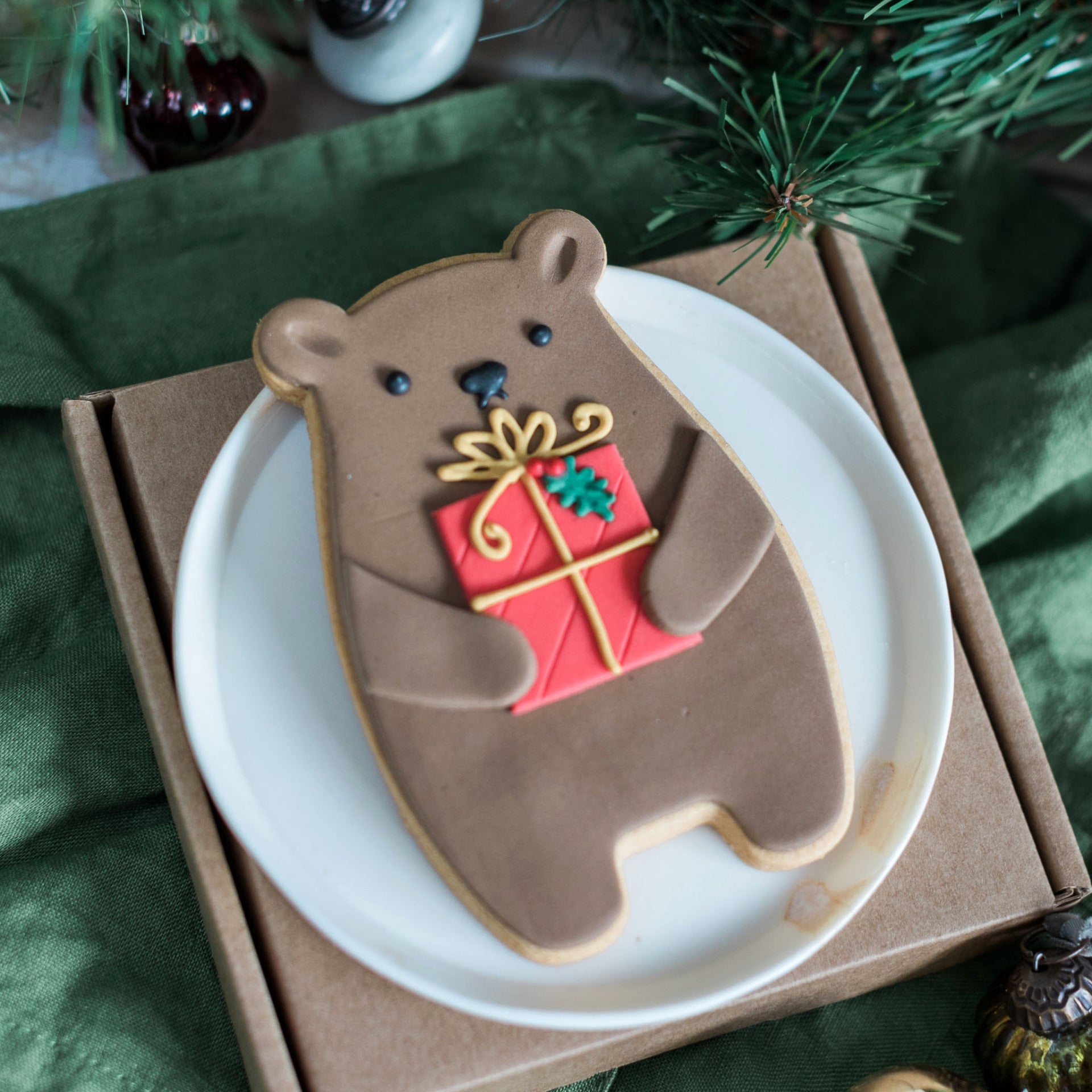 biscuit bear holding a present