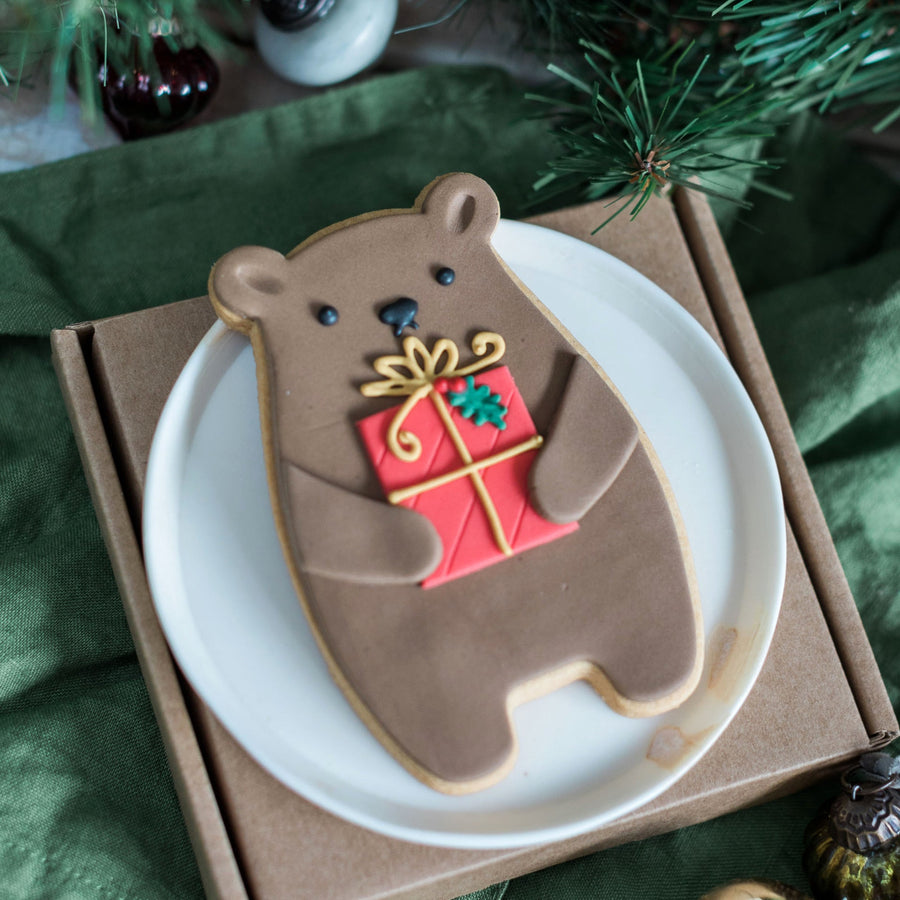 biscuit bear holding a present