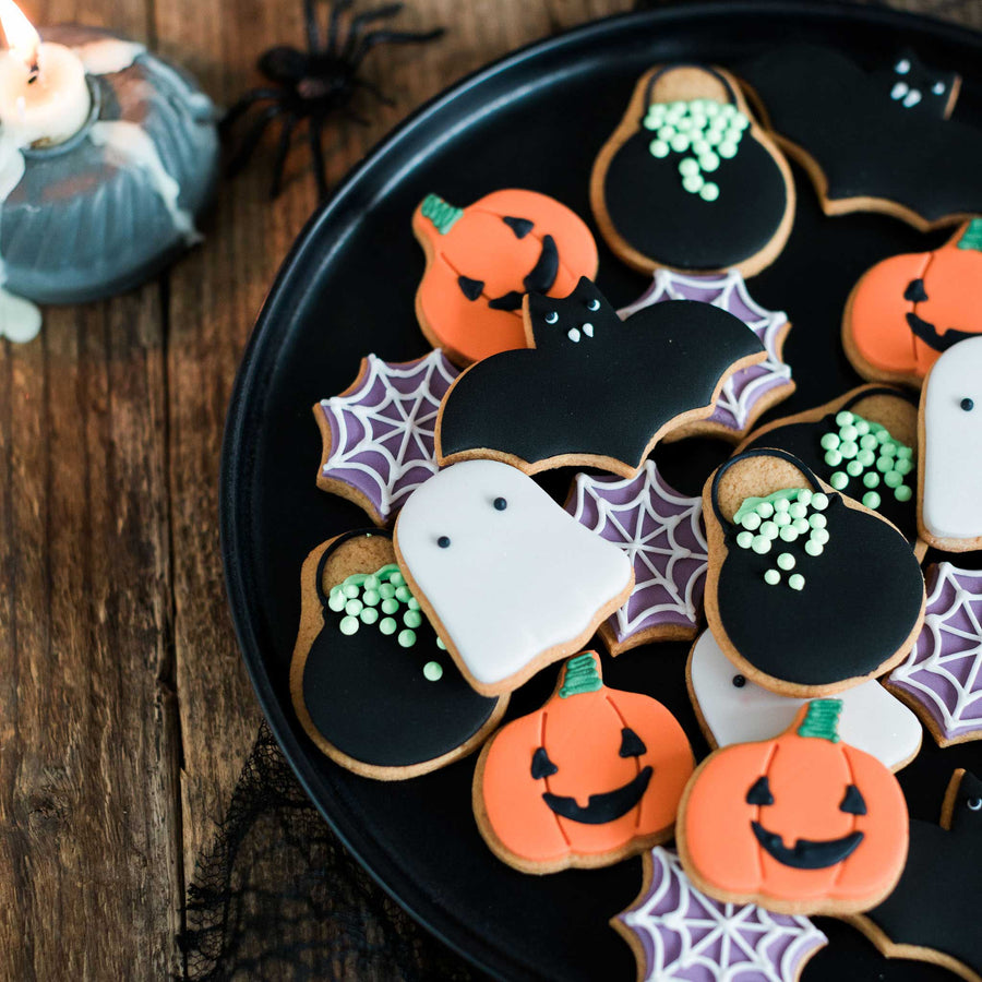 jar of cute halloween biscuits including pumpkins, ghosts, bats, cauldrons and spider webs