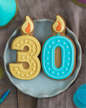 Honeywell Bakes 30th Birthday Biscuits - Two cookies shaped like candles with '30' on a blue plate.