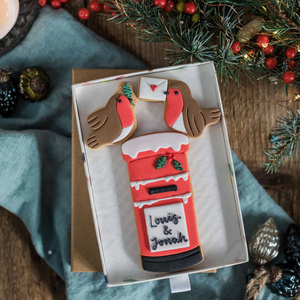 Christmas postbox biscuits, with snow and two robins, one holding a letter