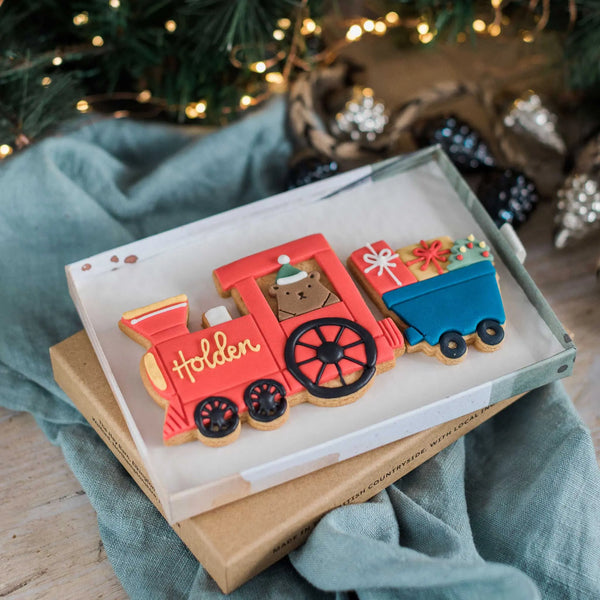 Christmas train to the north pole. Biscuit train with cute bear driving and a carriage full of Christmas presents