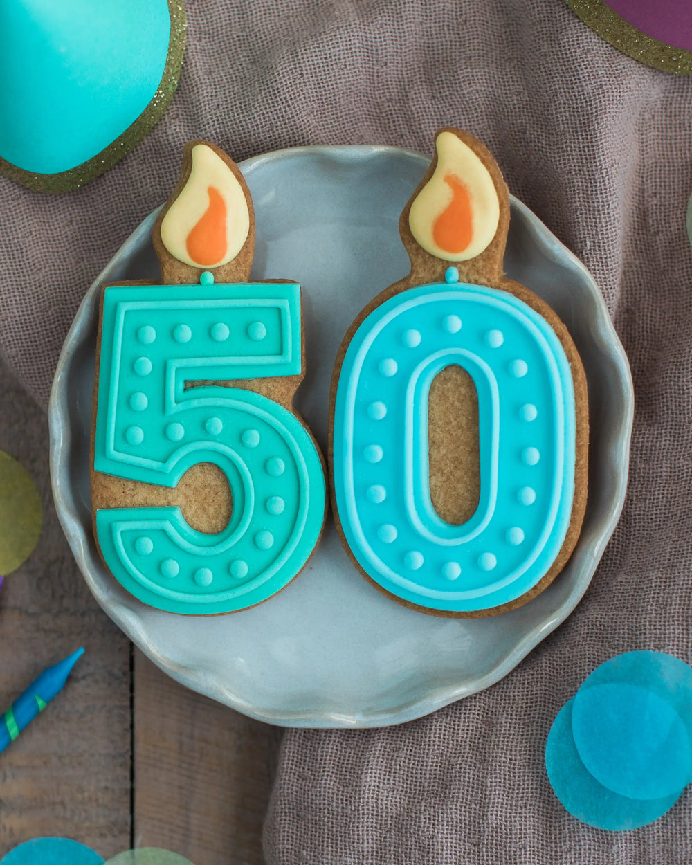 Honeywell Bakes 50th Birthday Biscuits - Two cookies shaped like candles with '50' on a blue plate.