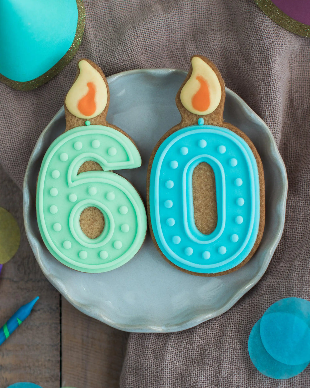 Honeywell Bakes 60th Birthday Biscuits - Decorative cookies shaped like candles with '60' on a plate