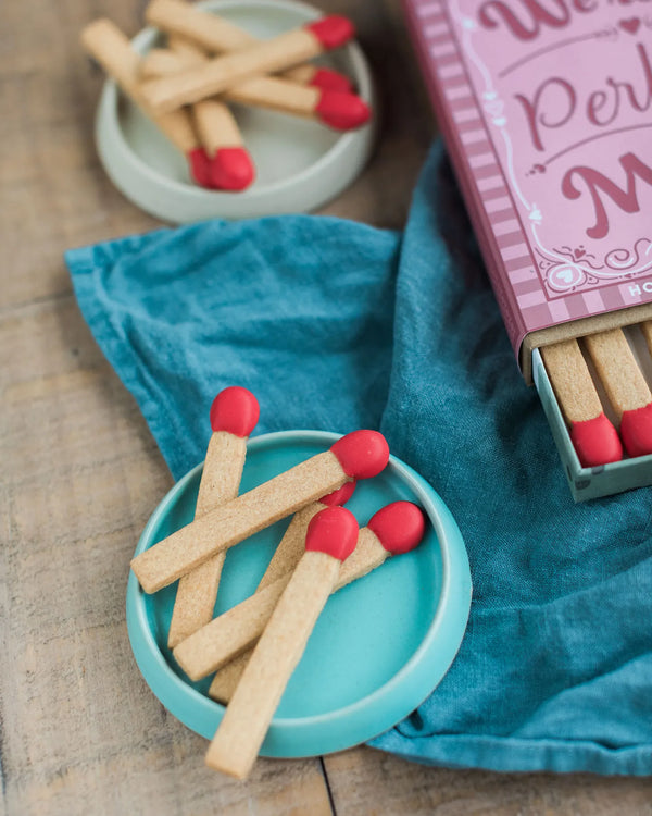Honeywell Bakes A Perfect Match - A Perfect Match Biscuit Gift - Shortbread Cookie Matches with red icing tips in small plates on a wooden surface