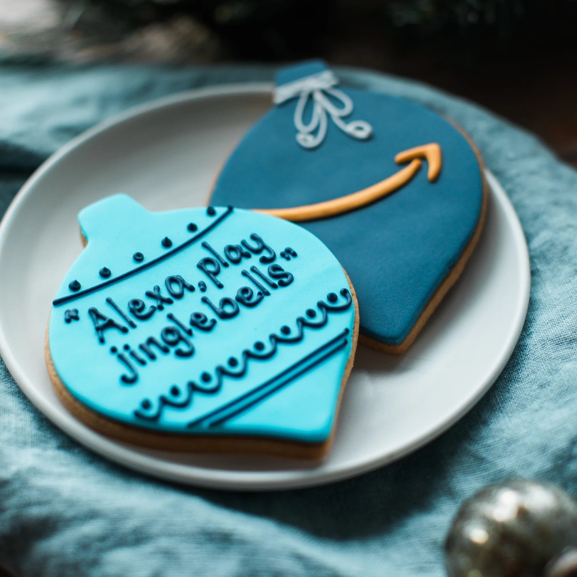 Honeywell Bakes Christmas Branded Biscuits; Amazon branded bauble shaped biscuits with 'Alexa, play jingle bells' and Amazon logo detail.