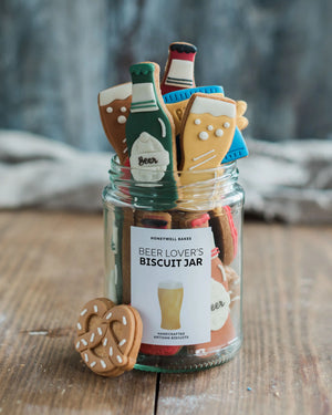 Honeywell Bakes Beer Lover’s Biscuit Jar - Jar of 'Beer Lover's Biscuit Jar' with cookie shapes on a wooden surface