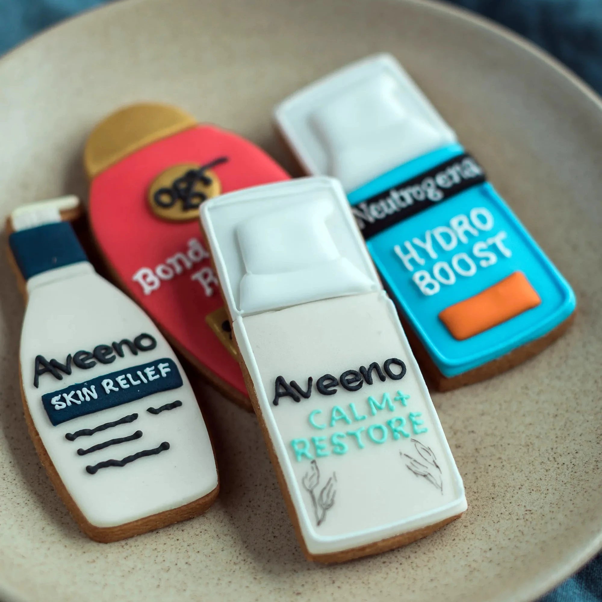 Honeywell bakes branded custom shape biscuits, Four Aveeno brand sugar cookies shaped like skincare bottles, for a product launch