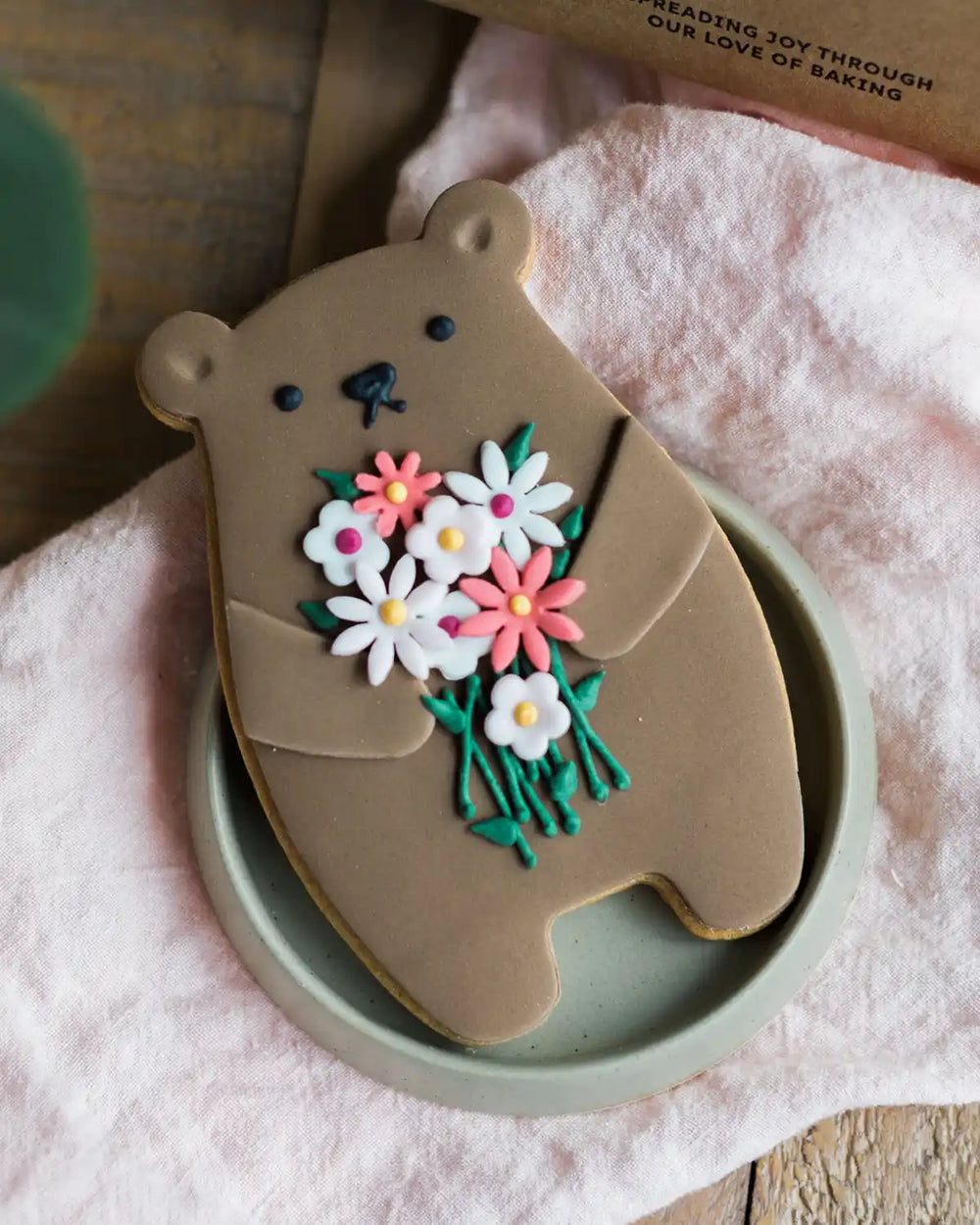 Honeywell Bakes Bunch Of Flowers Biscuit Bear - Cookie shaped like a bear with floral design on a pink surface