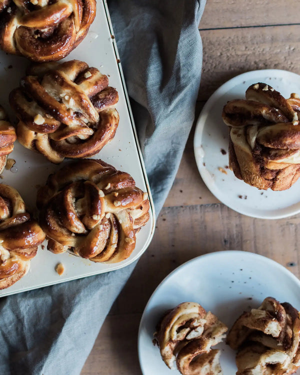 Honeywell Bakes Chocolate & Hazelnut Babka Buns - Baked pastries on a wooden table with a gray cloth.