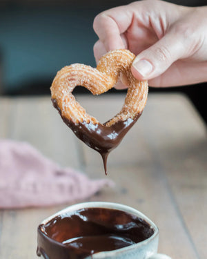 Honeywell Bakes Churros Kit For Baking - Heart-shaped churro being dipped into a cup of chocolate