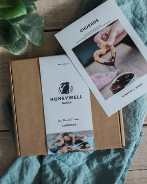 Honeywell Bakes churros baking kit with recipe card on a wooden surface.
