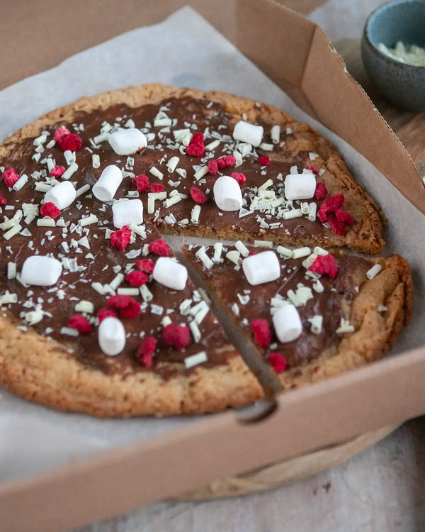 Honeywell Bakes Cookie Dough Pizza Baking Kit - Chocolate cookie pizza with marshmallows and raspberries in a cardboard box.