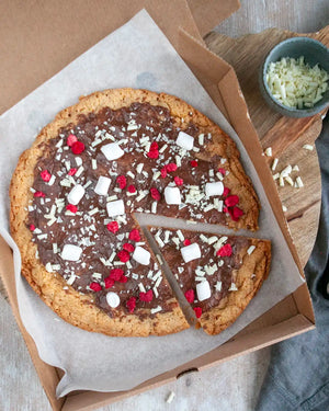 Honeywell Bakes Cookie Dough Pizza Baking Kit - Chocolate cookie pizza with toppings on a wooden board