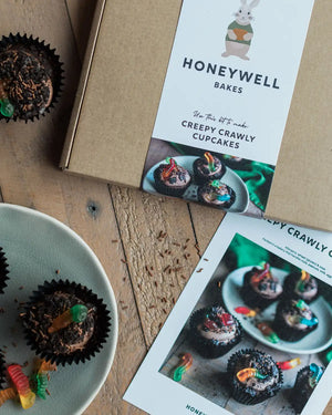 Honeywell Bakes Creepy Crawly Cupcake Baking Kit - packaging with cupcakes and instructions on a wooden surface