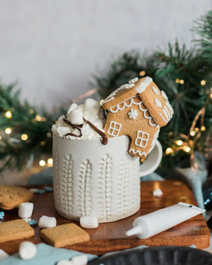 Honeywell Bakes DIY Tiny Gingerbread House Kit - biscuit gingerbread house on a mug of hot chocolate