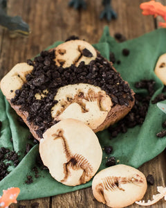 Honeywell Bakes Dinosaur Fossil Baking Kit - Dinosaur-themed brownie with cookies on a wooden surface