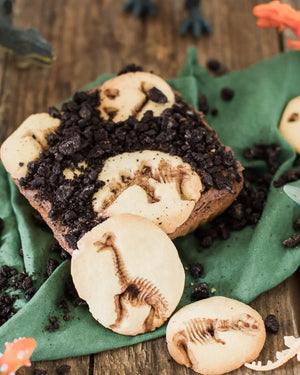 Honeywell Bakes Dinosaur Fossil Baking Kit - Dinosaur-themed brownie with cookies on a wooden surface