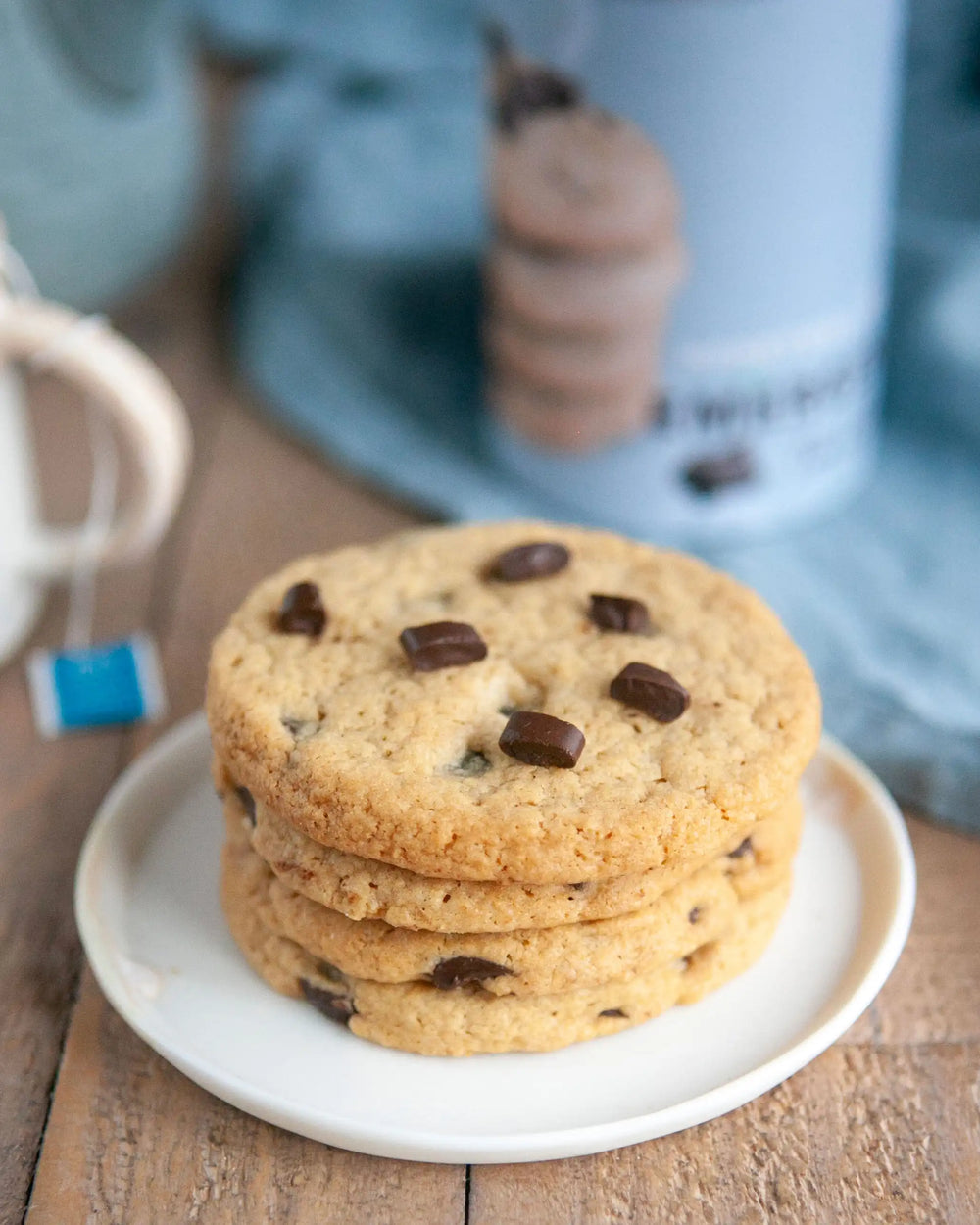Honeywell Bakes Emergency Tea & Cookies Kit - A stack of chocolate chip cookies with a cup of tea and can packaging