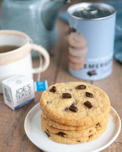 Honeywell Bakes Emergency Tea & Cookies Kit - A stack of chocolate chip cookies with a cup of tea and can packaging