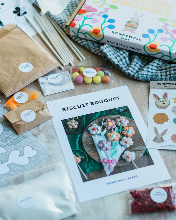 Honeywell Bakes Flower Biscuit Pops Baking Kit packaging and ingredients on a wooden surface