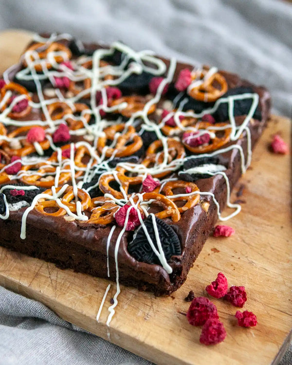 Honeywell Bakes Fully Loaded Brownie Baking Kit - Chocolate brownie with pretzels and raspberries on a wooden board