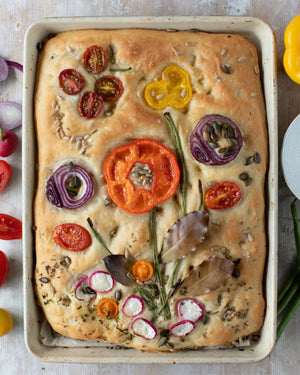 Honeywell Bakes Garden Focaccia Bread Baking Kit - Baked focaccia bread with various toppings on a baking tray.