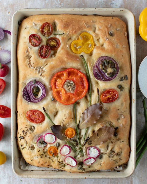 Honeywell Bakes Garden Focaccia Bread Baking Kit - Baked focaccia bread with various toppings on a baking tray.