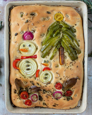 Honeywell Bakes Garden Focaccia Bread Baking Kit - Baked Focaccia bread with vegetable toppings shaped like a Christmas tree on a metal tray.