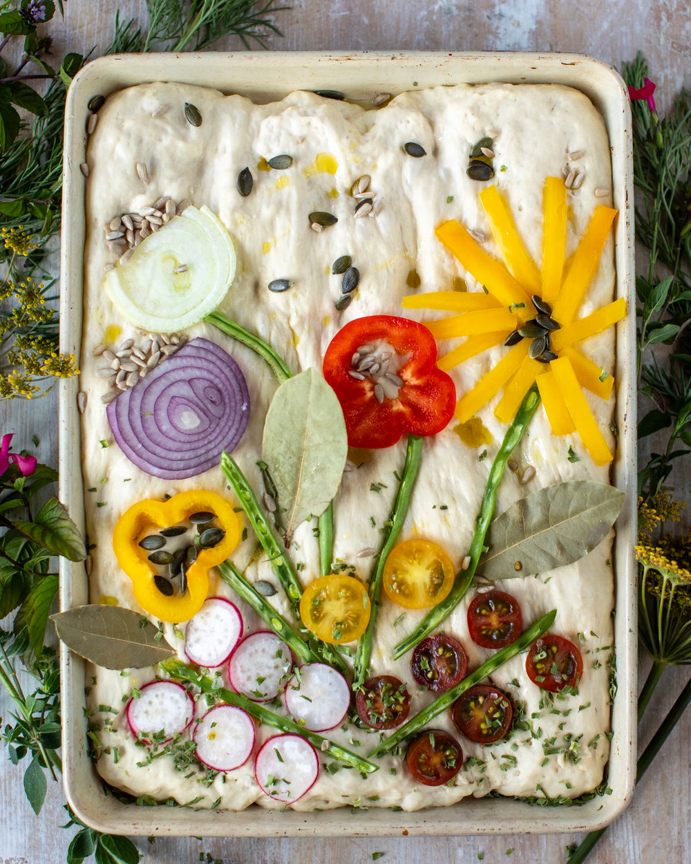 Honeywell Bakes Garden Focaccia Bread Baking Kit - Baked bread with floral designs on a wooden surface