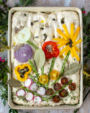 Honeywell Bakes Garden Focaccia Bread Baking Kit - Focaccia bread with various vegetables arranged like flowers on a rustic background