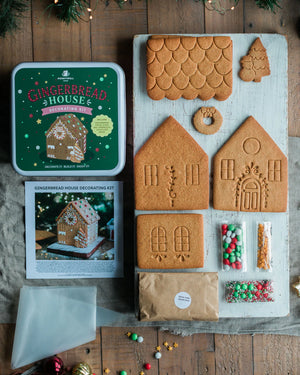Honeywell Bakes Gingerbread House Decorating Kit, A gingerbread house decorating kit including a tin of gingerbread house decorations, an instruction booklet, a piping bag, sprinkles and  gingerbread house pieces