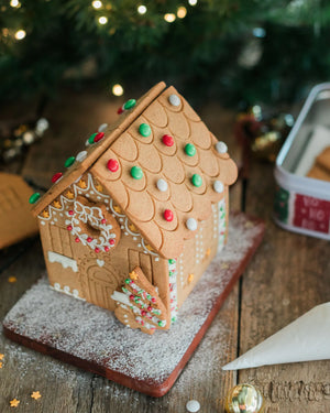 Gingerbread house decorating kit with pre-baked gingerbread house, icing and festive sprinkles