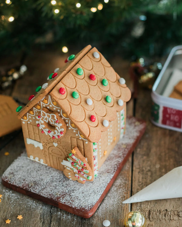 Gingerbread house decorating kit with pre-baked gingerbread house, icing and festive sprinkles