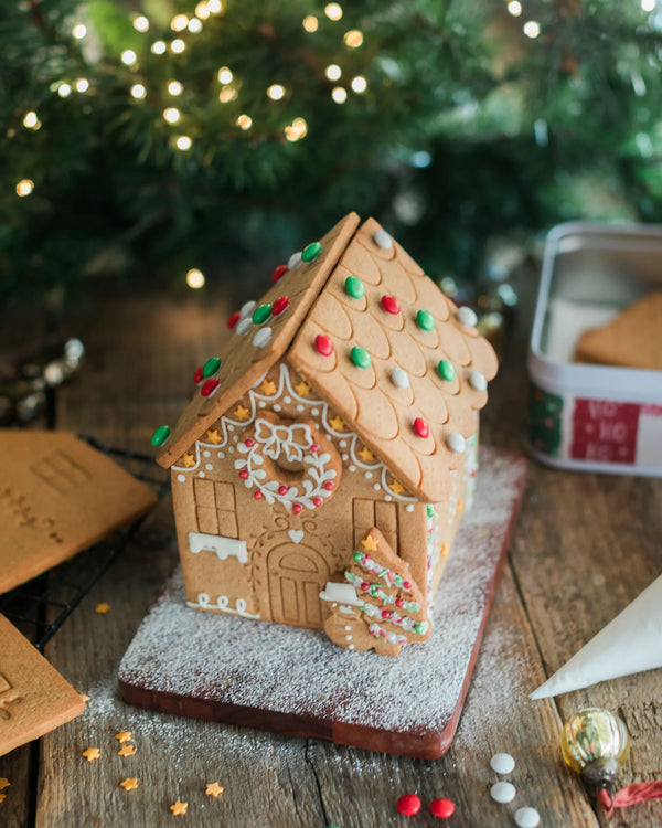 Gingerbread house decorating kit with pre-baked gingerbread house, icing and festive sprinkles