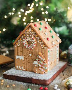 Gingerbread house decorating kit with pre-baked gingerbread house, icing and festive sprinkles