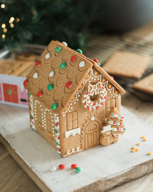 Gingerbread house decorating kit with pre-baked gingerbread house, icing and festive sprinkles