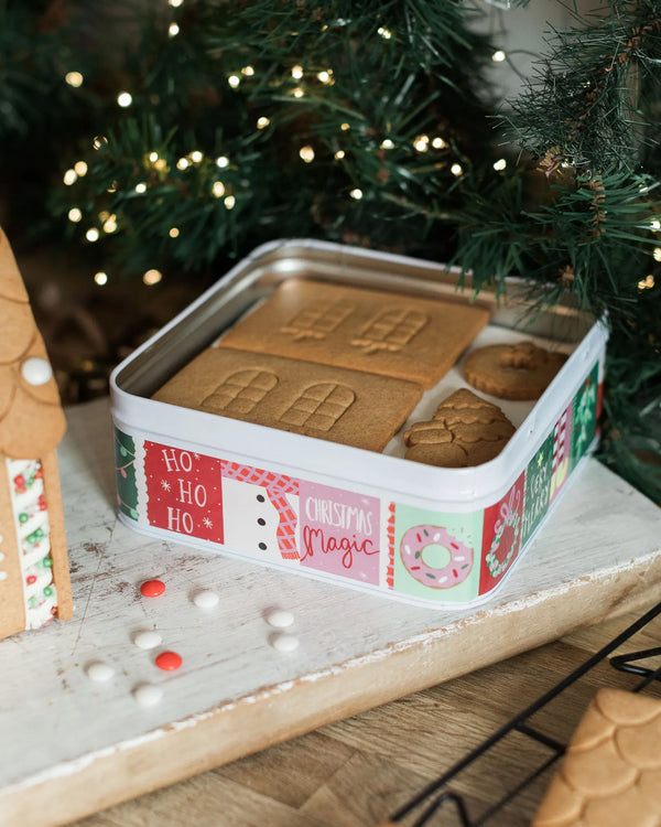 Pre-baked gingerbread house pieces supplied in a colourful Christmas keepsake tin, ready to assemble and decorate.