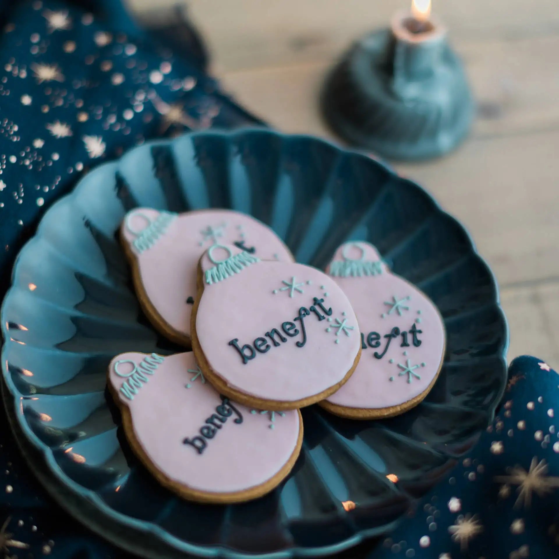 Christmas bauble cookies in light pink with Benefit cosmetics logo hand iced in black, with silver hand iced star detail 