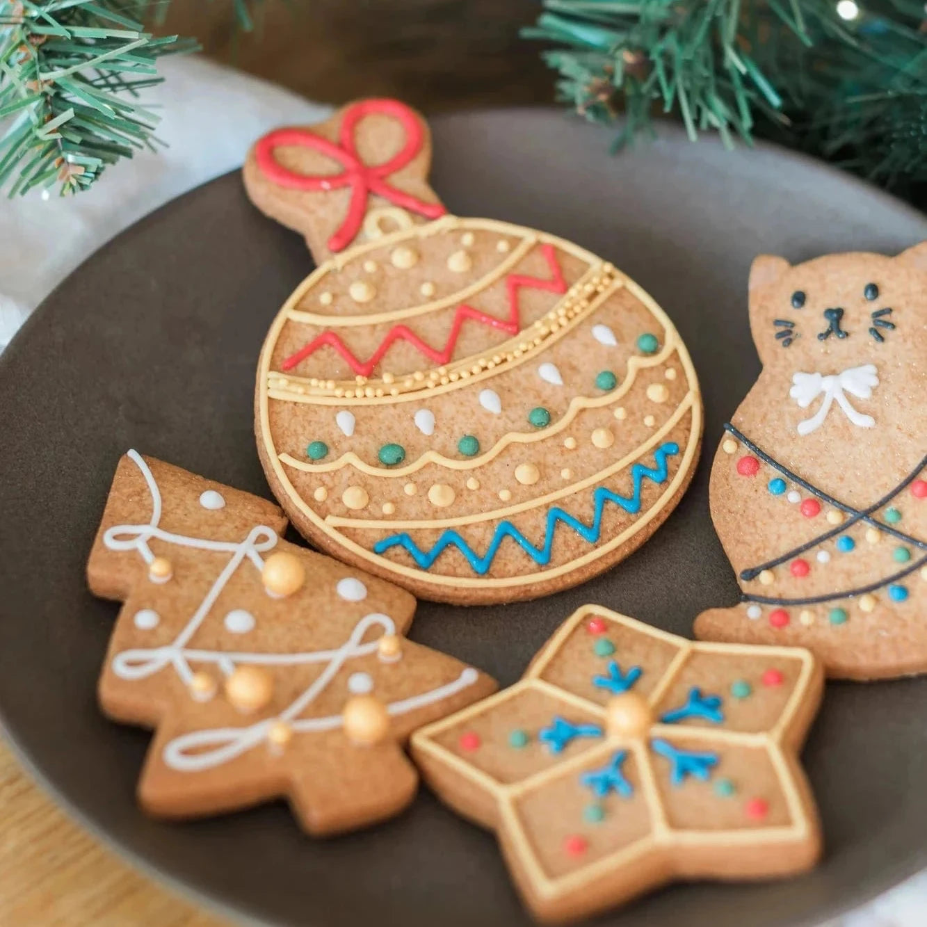 Honeywell Bakes iced Gingerbread Biscuits for Jo Malone; decorated gingerbread cookies shaped like an ornament, a Christmas tree, a star, and a cat.