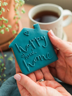 Honeywell Bakes Happy New Home Biscuit - blue biscuit embossed with a ‘Happy New Home’ design