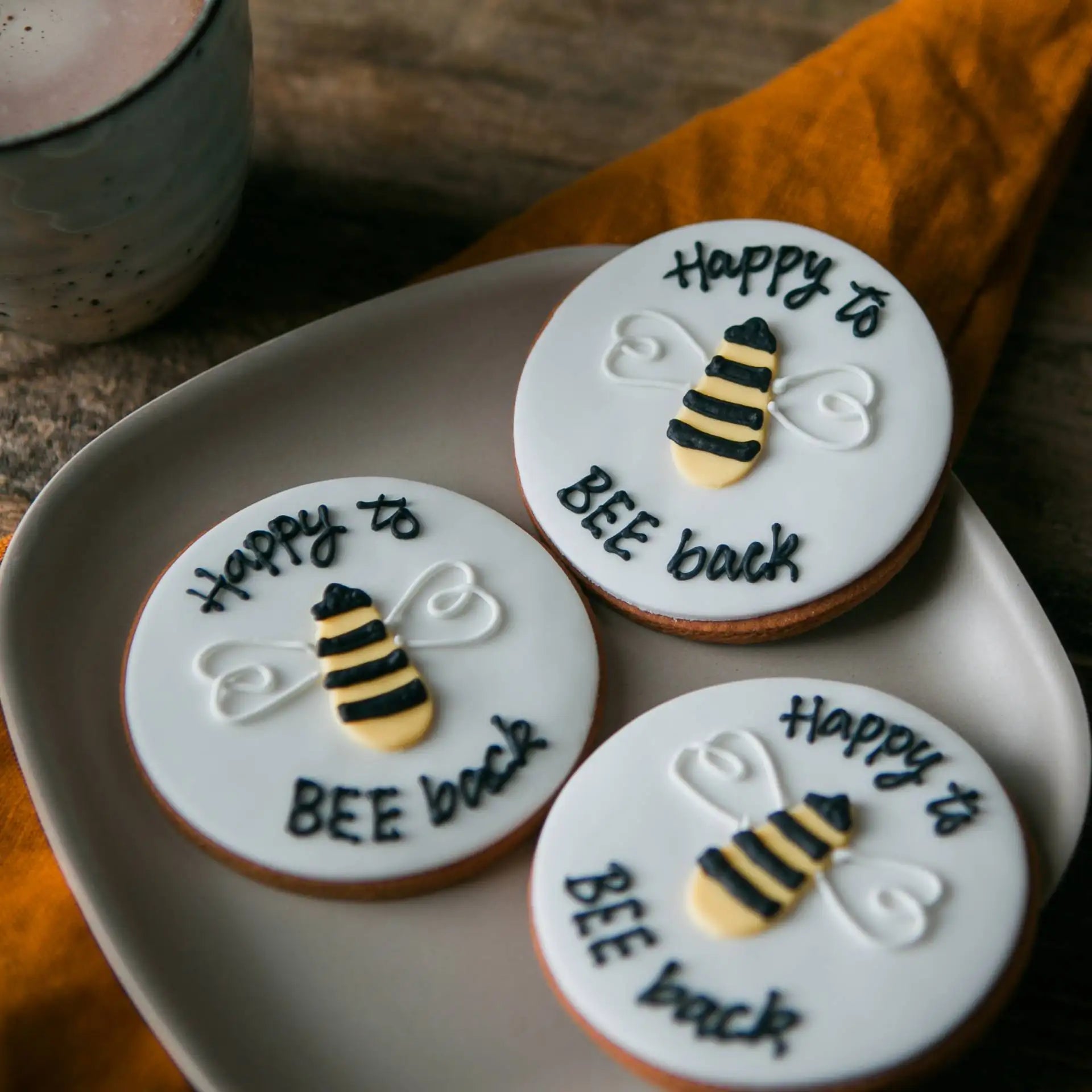 Hand iced biscuits with Happy to BEE back piped on, to welcome people back to the office