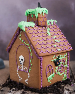 Honeywell Bakes Haunted Gingerbread House Baking Kit - Halloween-themed gingerbread house with a skeleton and black cat design on a dark background