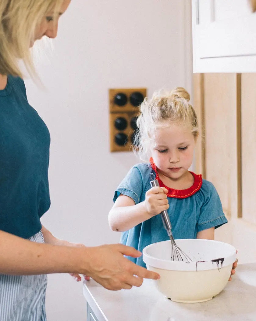 Honeywell Bakes Young Bakers Subscription, mum and daughter in a kitchen mixing ingredients in a bowl.