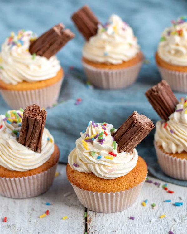 Honeywell Bakes Young Bakers Subscription, Five ice cream cupcakes with white whipped icing, colourful sprinkles, and flakes