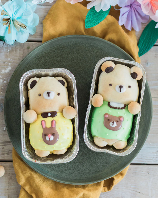 Honeywell Bakes Iced Teddy Bear Loaf Baking Kit - Two bear-shaped buns, iced with a decorative spring theme with flowers and a yellow fabric.