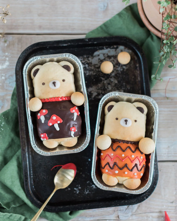 Honeywell Bakes Iced Teddy Bear Loaf Baking Kit - Two bear-shaped buns, iced with a decorative autumnal theme with mushrooms and green fabric.