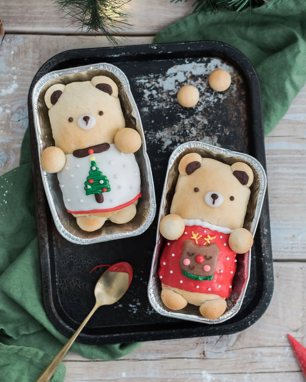 Honeywell Bakes Iced Teddy Bear Loaf Baking Kit - Two bear-shaped buns, iced with a decorative festive theme with Christmas trees and green fabric.