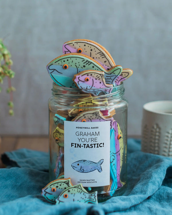 Honeywell Bakes Jar of fish-shaped cookies with a 'Graham, You're Fin-tastic!' tag on a blue towel.
